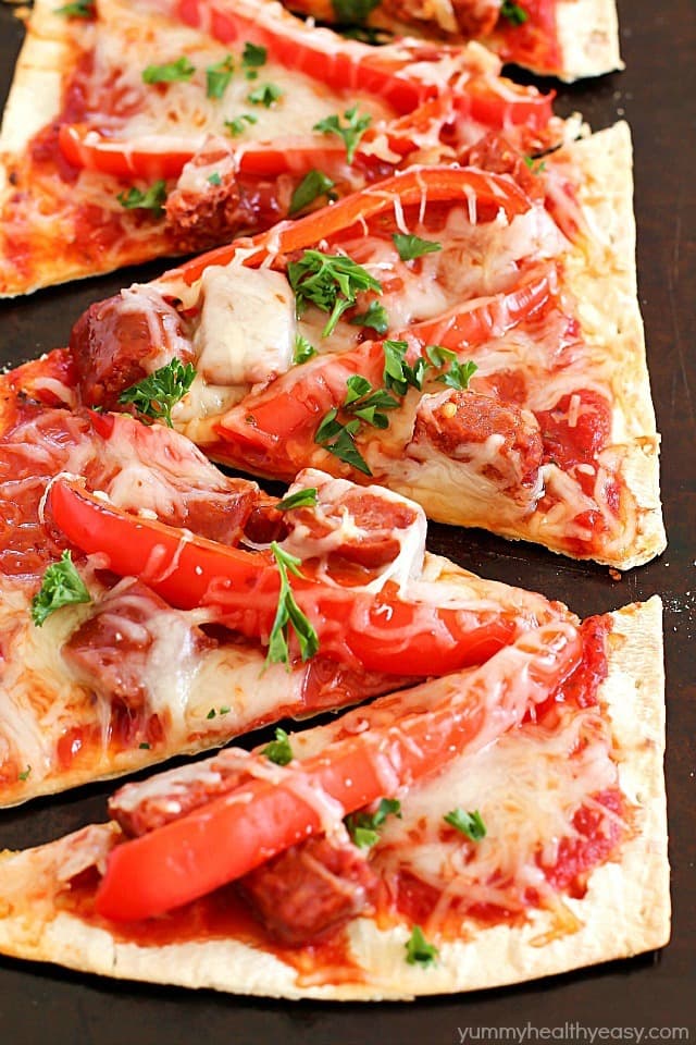 This Copycat Olive Garden Pepperoni & Sausage Flatbread Pizza is such a quick and easy dinner! Flatbread is layered with marinara sauce, roasted red peppers, pepperoni, sausage & cheese then baked. So easy and so delicious!! AD