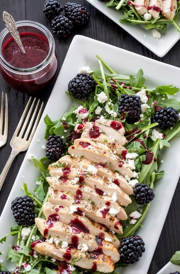 Peppery arugula topped with grilled chicken, blackberries, goat cheese, and the most delicious blackberry vinaigrette is perfect for a light and fresh dinner!