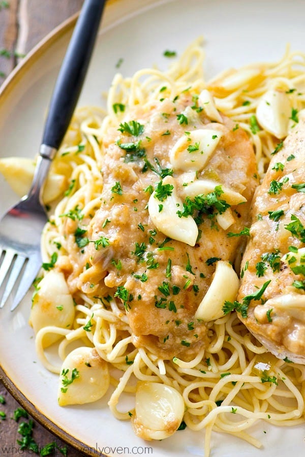 Crockpot Chicken with 40 Cloves of Garlic - chicken breasts cook for hours in an ultra-flavorful garlic sauce that’s amazing over hot pasta or rice! Just throw everything in the crockpot and forget about dinner. Perfect!