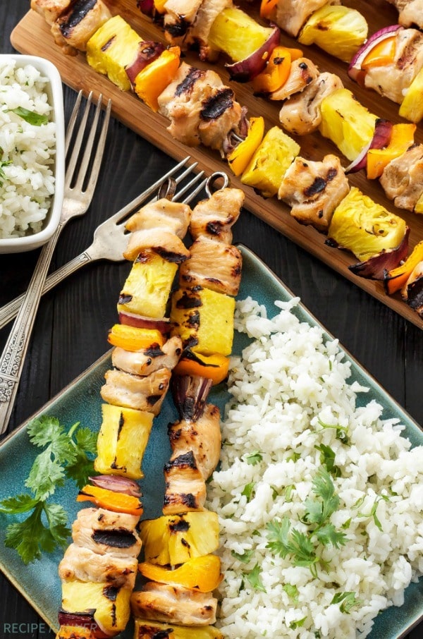 Hawaiian chicken skewers grilled with fresh pineapple, orange bell peppers, and red onions are an easy summer dinner! Serve the skewers with cilantro coconut rice as a delicious side dish!