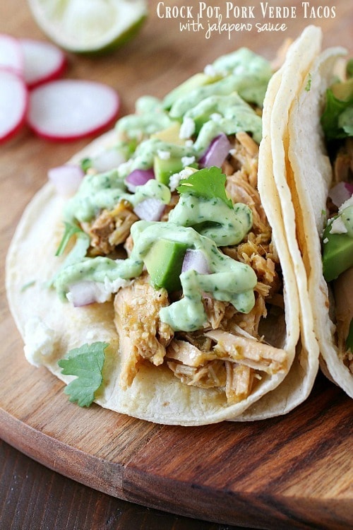 Celebrate Taco Tuesday with these Crock Pot Pork Verde Tacos served with a drizzle of amazing jalapeño sauce. You will love the flavor in these pork tacos and love how easy they are to make!