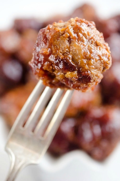 Crock Pot Cheddar BBQ Meatballs make for a comforting dinner paired with potatoes or an easy appetizer for the big game or holiday bash! Tender beef meatballs loaded with onion and cheese are simmered in your favorite BBQ sauce for a wonderful recipe made in your slow cooker.