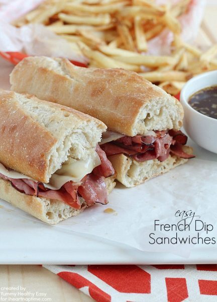 Easy French Dip Sandwiches on a white platter with a side of French fries.