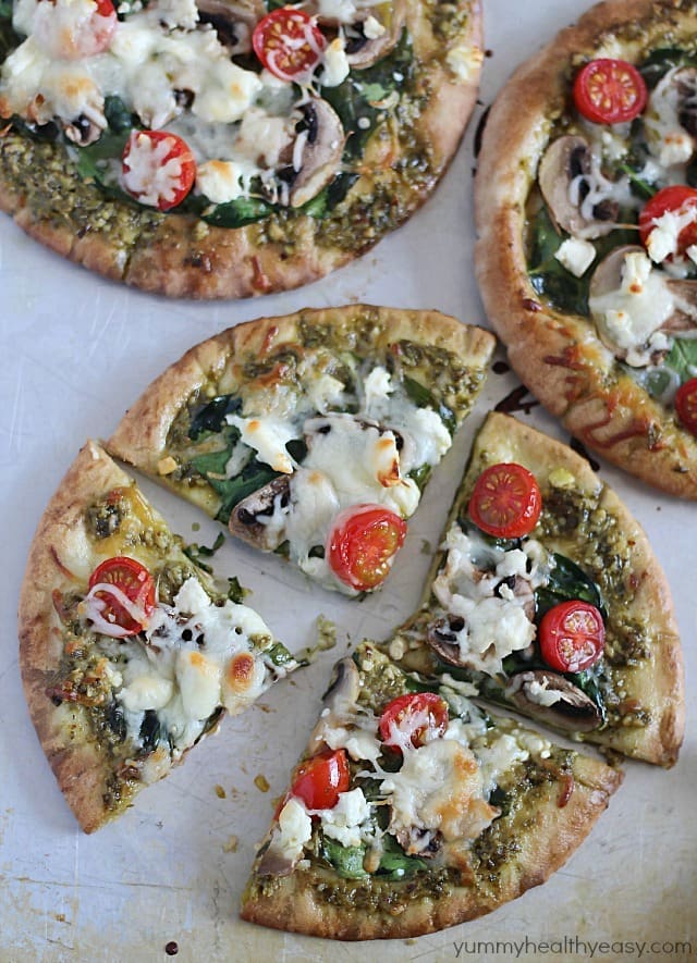These Easy Pesto Pita Bread Pizzas use pita bread as the crusts and are spread with pesto and topped with veggies. Delicious and healthy lunch, dinner or snack!