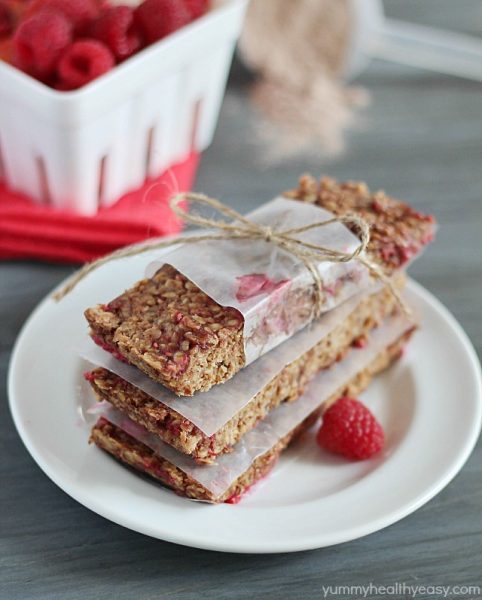 Stacked Raspberry Chocolate Protein Bars tied with twine and parchment paper.