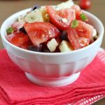 Greek Tomato Salad | easy salad made with tomatoes, cucumbers, olives, green onions & feta cheese and tossed with a homemade dressing. Light and delicious!