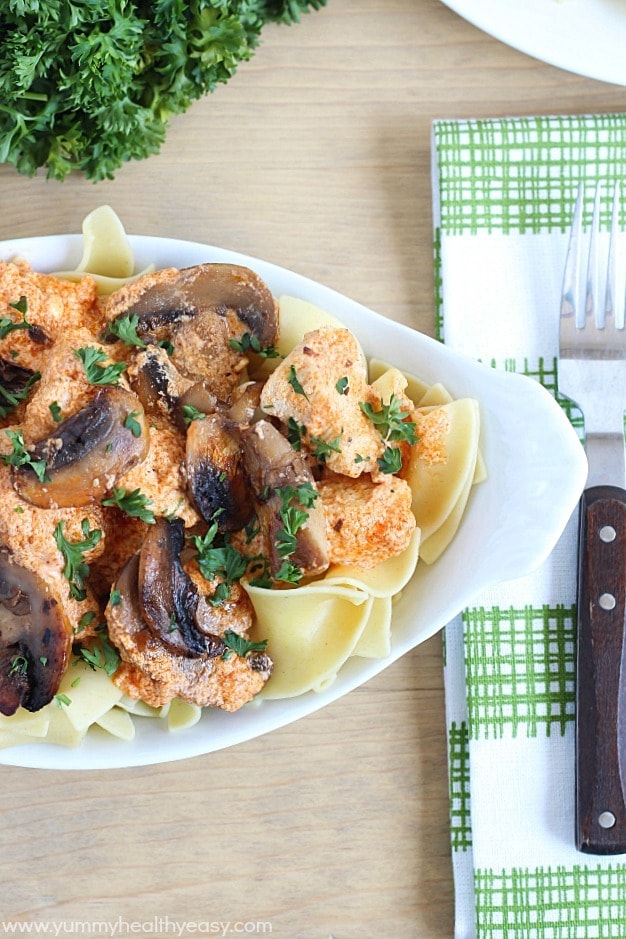 Healthy and creamy chicken stroganoff (made using yogurt, surprise!) and served over egg noodles. 