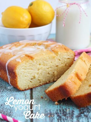 Lemon cake sliced with a glaze drizzled over the top.