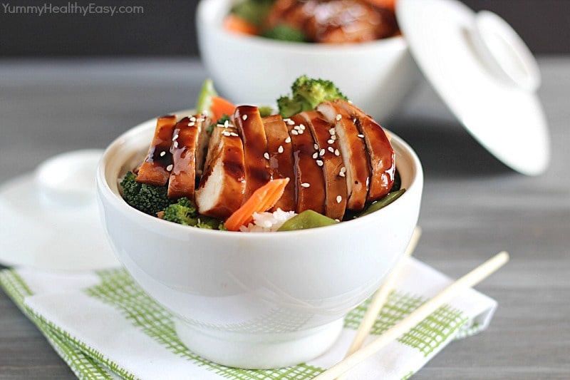 Delicious Chicken Teriyaki Bowls with chicken baked in a homemade teriyaki sauce layered on top of a bed of rice & veggies!