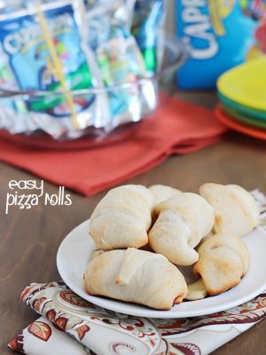Simple & delicious Pizza Rolls made from ready-made pizza dough, mozzarella sticks, pizza sauce and pepperoni all rolled together in a fun little bite and served with a refreshing Capri Sun! #ad