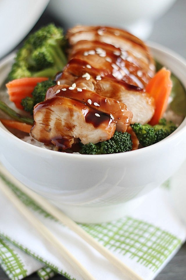 Delicious Chicken Teriyaki Bowls with chicken baked in a homemade teriyaki sauce layered on top of a bed of rice & veggies!