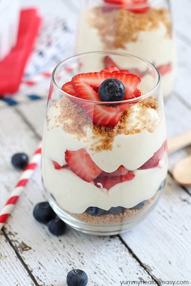 No-Bake Cheesecake Parfaits - layered with graham cracker crumbs, sliced strawberries, blueberries and easy no-bake cheesecake filling. Perfect for 4th of July!