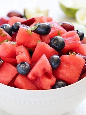 Watermelon Fruit Salad with cherries, blueberries and a delicious mint-lime dressing. Easy, fresh and the perfect summer side dish!