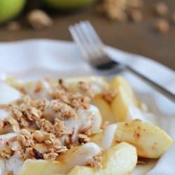 Baked Apples tossed in maple syrup and served with spiced yogurt and granola. Easy and healthy dessert, snack or breakfast!