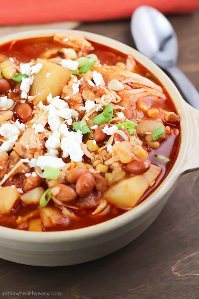 Yummy crock pot chicken chili stew with pinto beans, potatoes, corn, spices and topped with feta cheese. Easy prep and so delicious!
