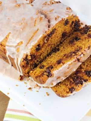 Chocolate Chip Pumpkin Loaf - so moist and delicious, with a spiced glaze drizzled over the top. Best pumpkin bread ever!