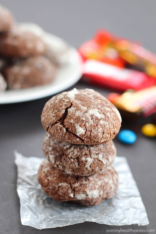 Chocolate Surprise Crinkle Cookies filled with pieces of your favorite candy inside and rolled in powdered sugar - the best way to use up any leftover candy! #cookies #halloween #leftovercandy #dessert #chocolate #surprise via @jennikolaus