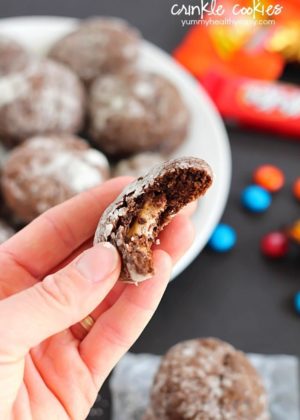 Chocolate Surprise Crinkle Cookies filled with pieces of your favorite candy inside and rolled in powdered sugar - the best way to use up any leftover candy!