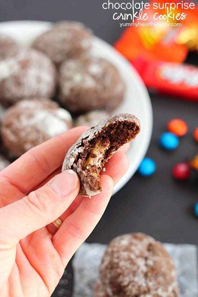 Chocolate Surprise Crinkle Cookies filled with pieces of your favorite candy inside and rolled in powdered sugar - the best way to use up any leftover candy! #cookies #halloween #leftovercandy #dessert #chocolate #surprise via @jennikolaus
