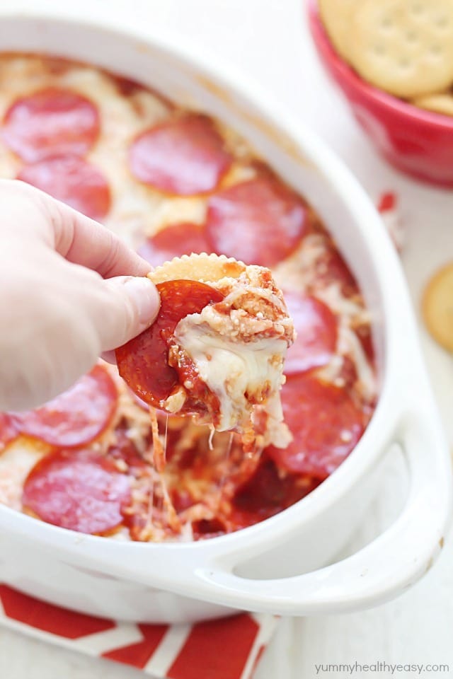 The most unbelievable pizza dip! A layer of herbed cream cheese, homemade sauce, cheese and then topped with pepperoni. AMAZING!