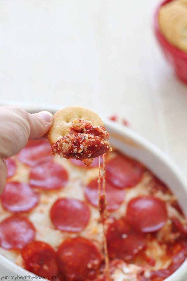 The most unbelievable pizza dip! A layer of herbed cream cheese, homemade sauce, cheese and then topped with pepperoni. AMAZING!