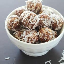 A white bowl full of No-Bake Nut & Date Energy Balls