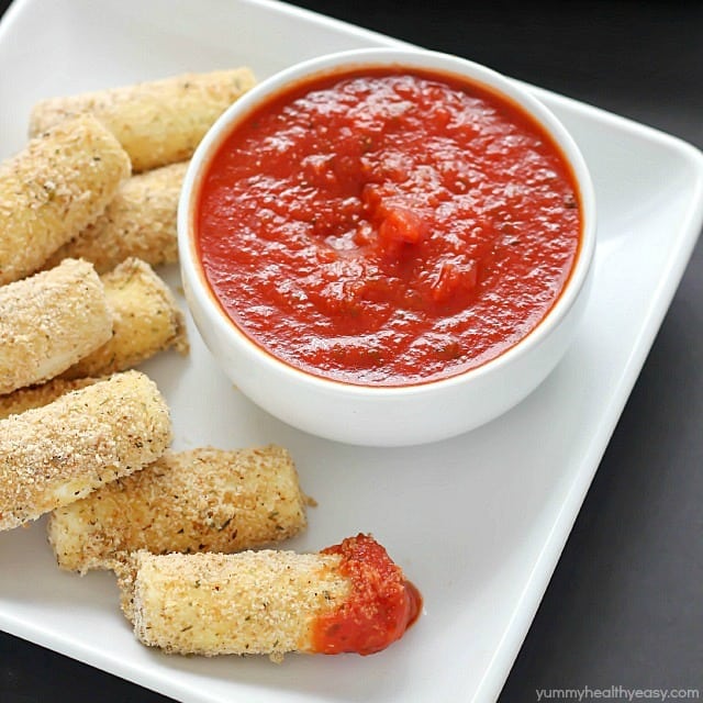 Quick and easy Baked Mozzarella Sticks for the win! A fast crowd-pleasing appetizer of warm and gooey cheese dipped in marinara sauce - yum!
