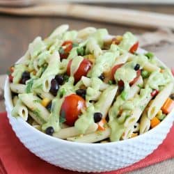 A simply delicious side dish, Mexican Pasta Salad - with black beans, corn, bell pepper, cilantro, tomatoes, and an avocado dressing.