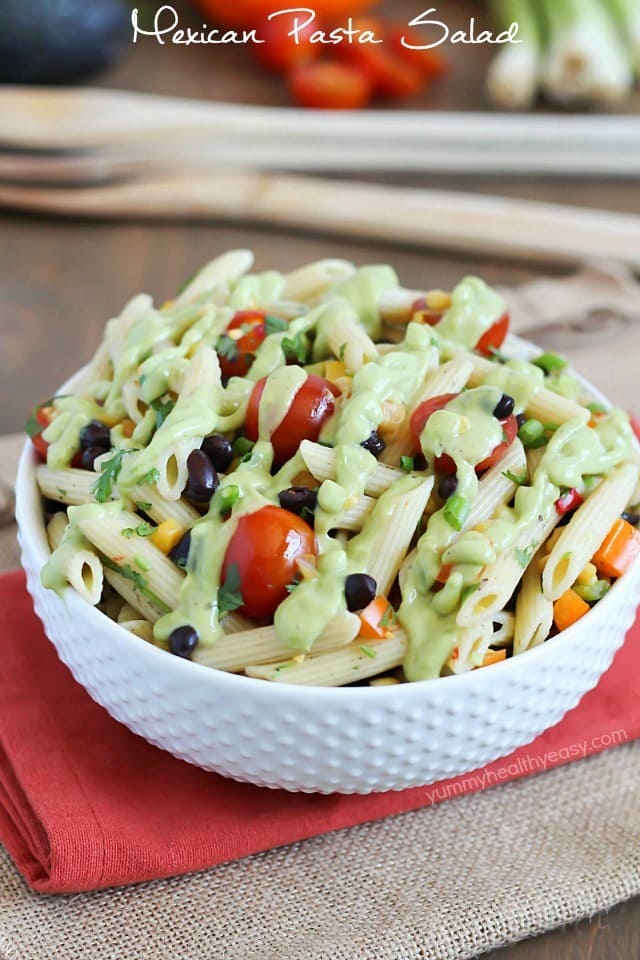 A simply delicious side dish, Mexican Pasta Salad - with black beans, corn, bell pepper, cilantro, tomatoes, and an avocado dressing. 