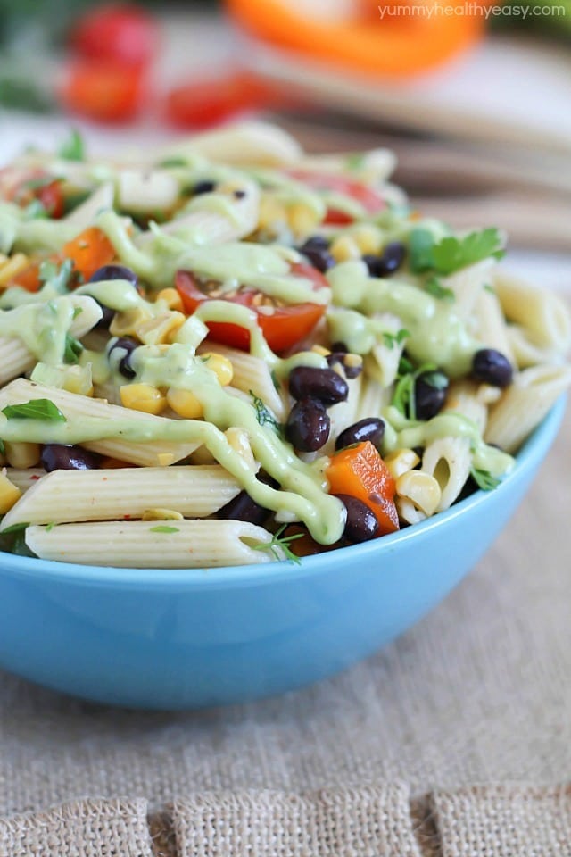 A simply delicious side dish, Mexican Pasta Salad - with black beans, corn, bell pepper, cilantro, tomatoes, and an avocado dressing. 