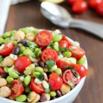 Welcome spring by making edamame salad! It's a healthy and delicious salad with a southwestern flair, full of beans, corn, tomatoes, cilantro and of course edamame, all tossed in a delicious light dressing.
