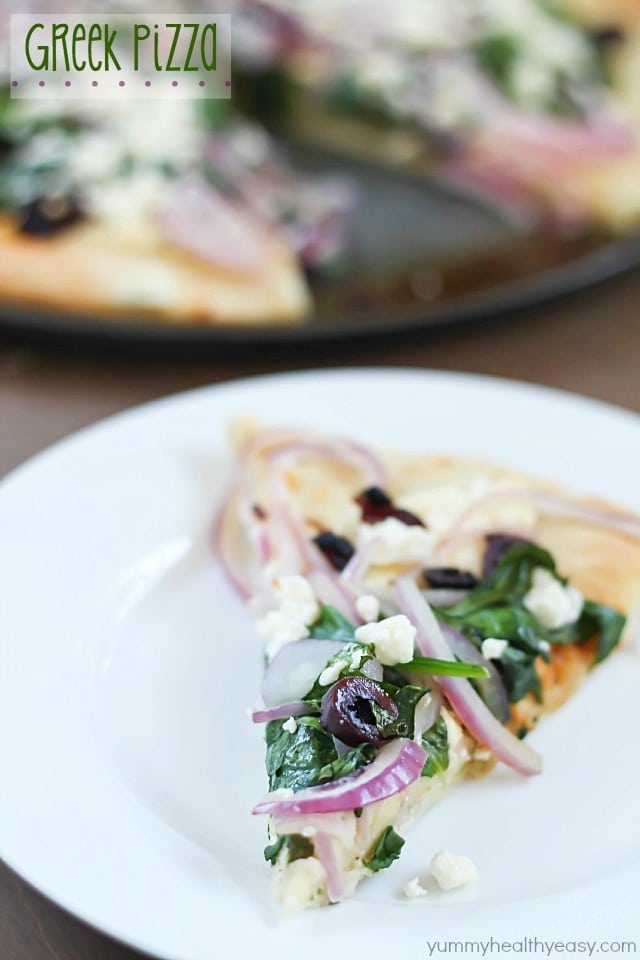 Easy Greek Pizza Recipe with a mayo & garlic spread and topped with feta, red onion, spinach, sun dried tomatoes and kalamata olives. Crazy delicious! 