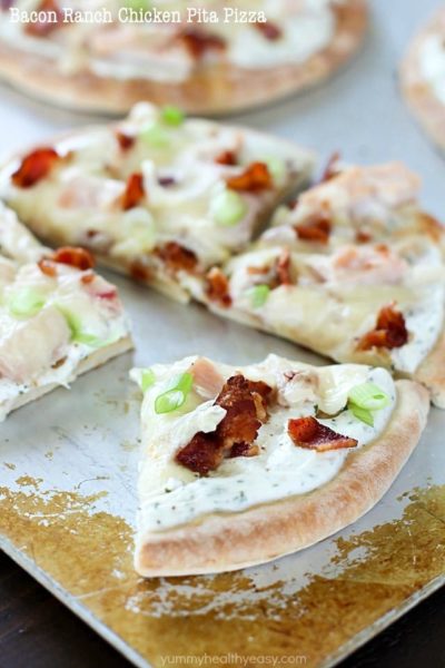 Bacon Ranch Chicken Pita Pizza on a cookie sheet, sliced up!