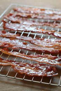 Brown Sugar Bacon aka Candied Bacon aka the Best Bacon EVER! This easy bacon is baked in the oven with a topping of brown sugar and pepper, and comes out sticky, sweet & savory. Absolutely drool-worthy!