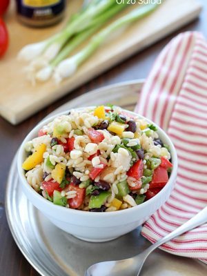 This Healthy Southwestern Orzo Salad recipe is full of veggies, black beans, orzo, & feta cheese all smothered in a delicious dressing! #ad