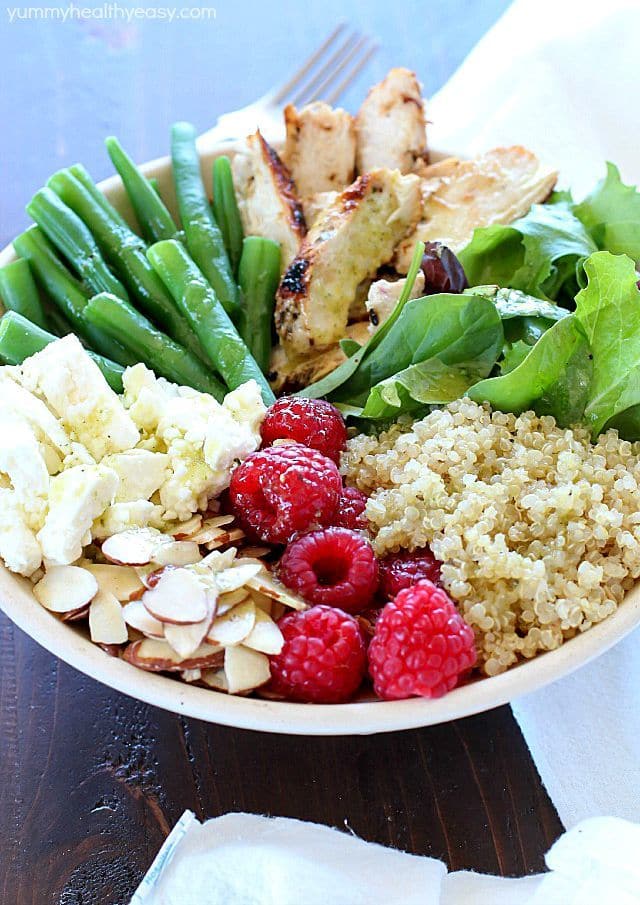 Check out this yummy salad bowl recipe full of grilled chicken, cooked quinoa, kale, raspberries, sliced almonds, feta cheese, green beans and a homemade basil vinaigrette. Super healthy and absolutely delicious! #OrganicBound #Ad