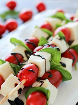 Summer afternoons call for these fun Caprese Skewers! Cherry tomatoes, fresh basil and cubes of mozzarella cheese threaded on skewers and drizzled with an easy balsamic reduction. Delicious!