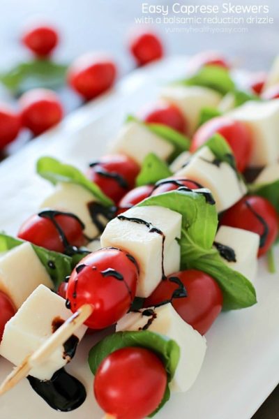 Summer afternoons call for these fun Caprese Skewers! Cherry tomatoes, fresh basil and cubes of mozzarella cheese threaded on skewers and drizzled with an easy balsamic reduction. Delicious!