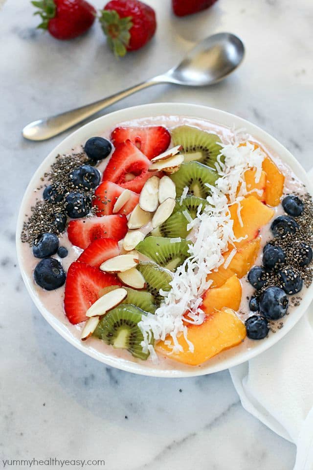 This Tropical Smoothie Bowl Recipe is the perfect breakfast or snack! It's dairy-free, gluten-free, full of protein and fresh fruit and totally delicious. Satisfying and easy to make, too! #SilkCashew #ad
