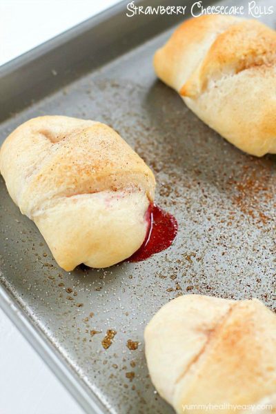 Need a quick and easy dessert? Try these Strawberry Cheesecake Rolls! Crescent rolls spread with a cream cheese mixture and a scoop of strawberries rolled together and baked. Delicious!