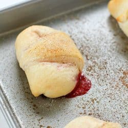 Need a quick and easy dessert? Try these Strawberry Cheesecake Rolls! Crescent rolls spread with a cream cheese mixture and a scoop of strawberries rolled together and baked. Delicious!