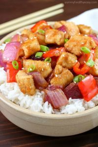 The most incredible Orange Chicken Stir Fry in a white bowl with chopsticks.