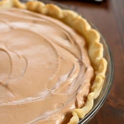An incredibly Easy Chocolate Pie recipe that my Mom makes every Thanksgiving as a tradition. This is so simple and uses no pudding. This is a family favorite chocolate pie! A must for your holiday dessert table!