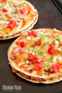 Tray with two Mexican Pizzas. Easy, yummy recipe of layered flour tortillas with a filling of refried beans, shredded chicken and salsa.