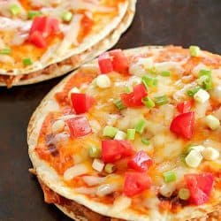 Tray with two Mexican Pizzas. Easy, yummy recipe of layered flour tortillas with a filling of refried beans, shredded chicken and salsa.