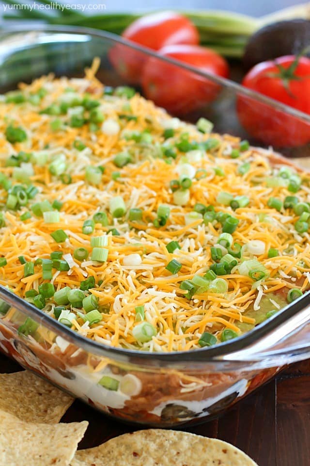 You will love this 7 Layer Bean Dip! This is the quick & easy recipe my Mom always uses for the most requested, most popular appetizer in our family. It's perfect to bring to a party or to serve during game day!