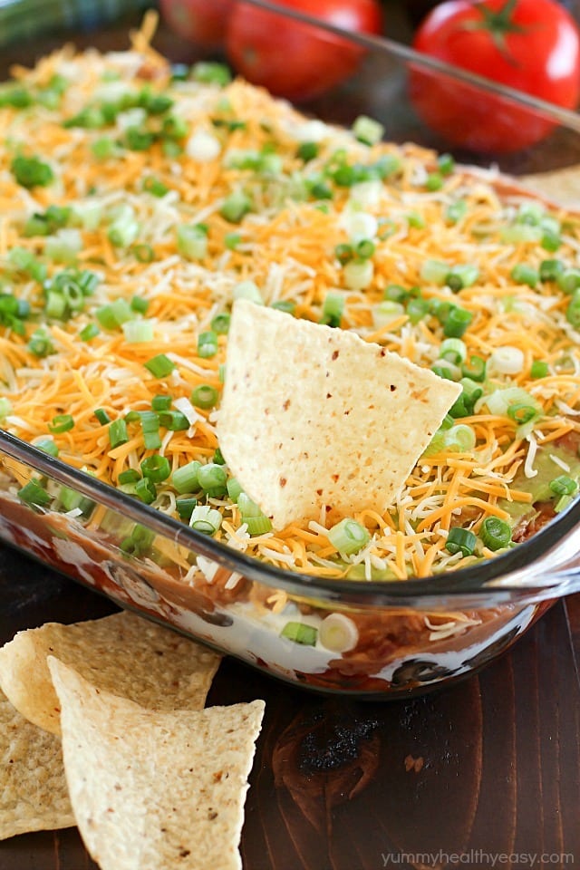 You will love this 7 Layer Bean Dip! This is the quick & easy recipe my Mom always uses for the most requested, most popular appetizer in our family. It's perfect to bring to a party or to serve during game day!