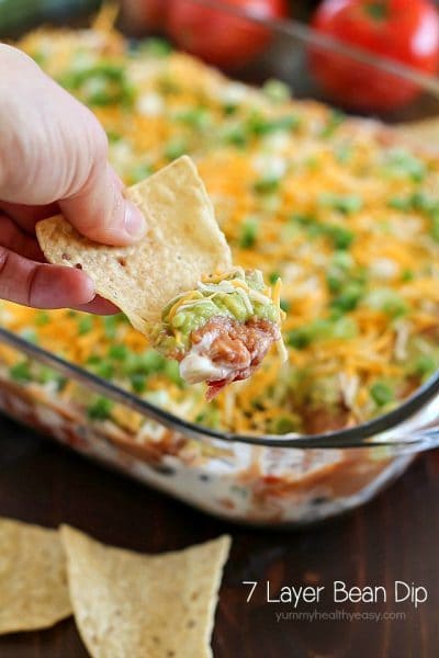 You will love this 7 Layer Bean Dip! This is my Mom's quick & easy recipe for the most requested, most popular appetizer in our family. It's perfect to bring to a party or to serve during game day!