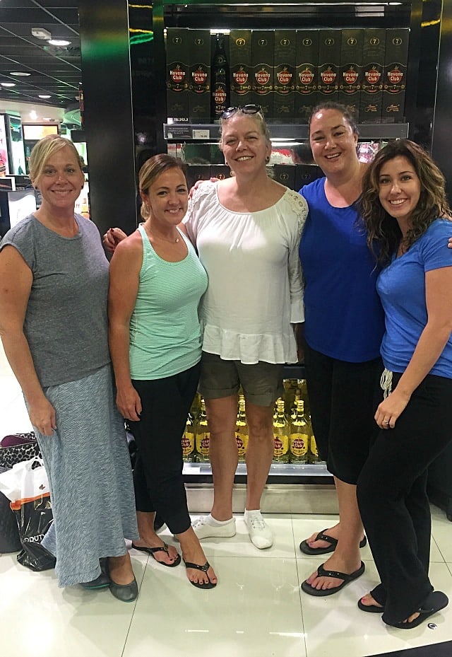 The end of the trip, posing near the duty-free goods in the airport with friends. :) (Jamaica Retreat - Eat, Love Sandals)