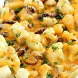 Cheesy Cauliflower Casserole makes the most delicious side dish or meatless main dish! Full of flavor with cauliflower, sautéed mushrooms & leeks, and an easy cheesy sauce that won't pack on the calories. This is incredible! AD